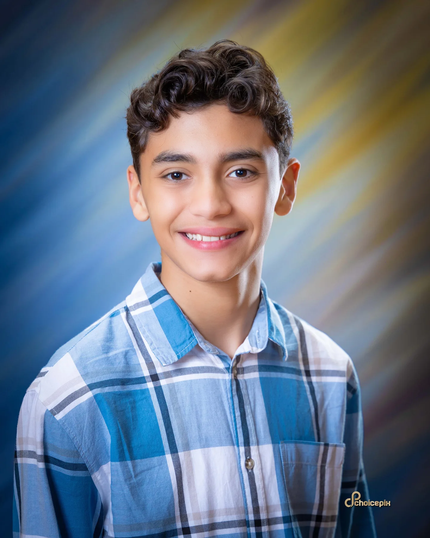Middle school portrait in a blue plaid shirt